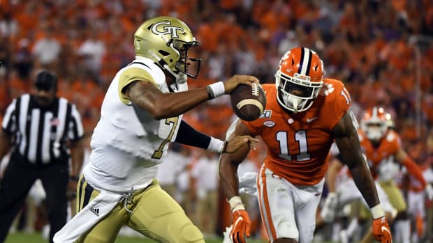 Aug 29, 2019; Clemson, SC, USA; Georgia Tech Yellow Jackets quarterback Lucas Johnson (7) carries the ball against Clemson Tigers linebacker Isaiah Simmons (11) during the second quarter at Clemson Memorial Stadium.